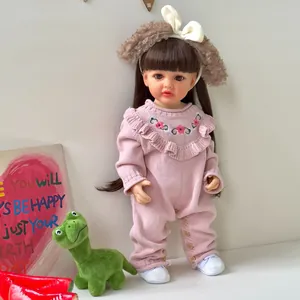 55cm realistic reborn baby doll with long brown hair and pink knitted floral outfit