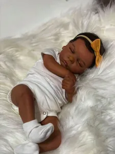 Detailed close-up of 49cm reborn doll with dark skin tone sleeping on plush carpet