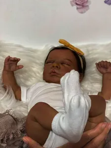 Close-up of 49cm reborn doll with dark skin tone showing realistic 3D skin texture