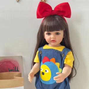 Detailed view of reborn baby doll featuring long brown hair and a bright red bow headband