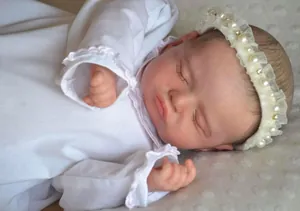 Close-up of 49cm Rosalie reborn baby doll with 3D skin and beaded lace headband