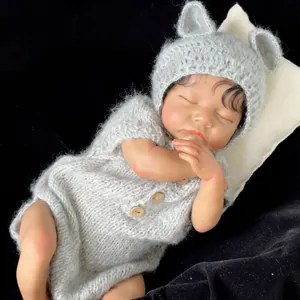Lifelike 19-inch reborn baby doll Levi with brown skin in gray bear outfit
