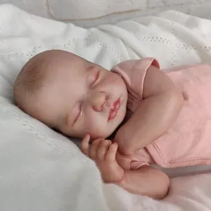 Close-up of sleeping reborn baby doll with realistic hand-painted skin details
