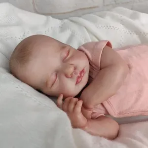 Lifelike 49cm reborn baby doll LouLou in pink onesie sleeping on white knit blanket