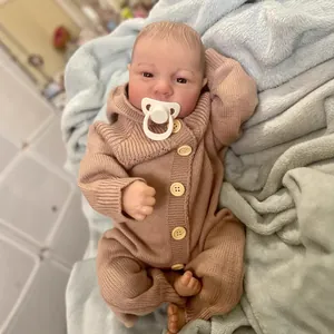 Realistic 19 inch reborn baby doll Levi in brown knit romper with pacifier accessory