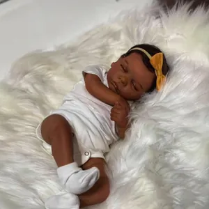 Realistic 49cm dark skin reborn baby doll in white bodysuit with yellow headband