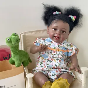 Lebensechte 60cm Reborn-Puppe Yannik mit dunkler Haut im blumigen weißen Kleid