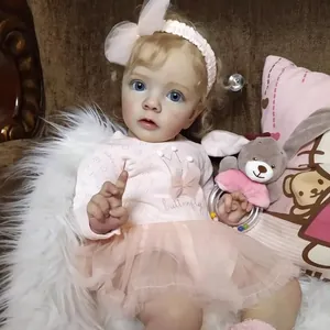 Realistic reborn doll Missy with golden curls and blue eyes in a pink tulle dress