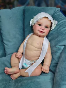 Close-up of realistic Maddie reborn baby doll with green eyes and lace headband