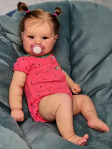 Close-up of lifelike Reborn Doll with realistic skin texture and a heart pacifier