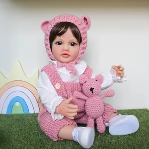 Lifelike Reborn Baby Doll Betty in pink hand-knitted outfit with a matching bear toy