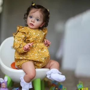 Realistic reborn baby doll Missy with curly brown hair in ginger floral romper