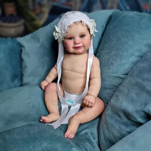 50cm lifelike reborn baby doll Maddie with white lace bonnet and printed diaper on blue fabric