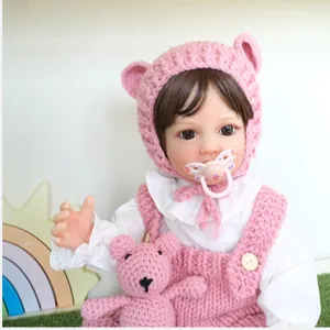55cm lifelike Betty reborn doll in pink knit outfit and white lace shirt with small bear toy