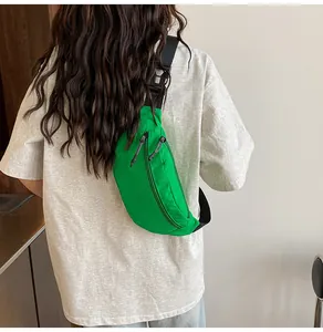 Close-up of bright green waterproof nylon sports bag with black adjustable strap and buckles