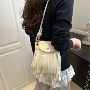Vintage cream faux suede fringe crossbody bag with bohemian style tassels and strap