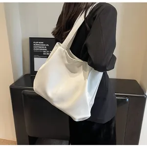Detailed view of large white tote bag with soft PU leather texture and vertical stitching
