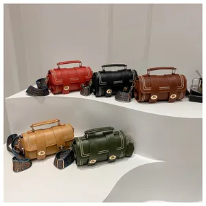 Close-up of leather crossbody bags with metal twist locks and woven straps in five colors