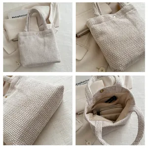 Detail view of woven tote bag showing internal zipper pocket and magnetic snap closure
