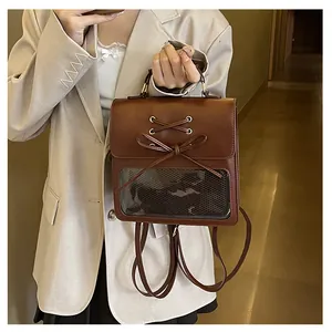 Detail of dark brown backpack featuring a cross-lace bow and clear window pocket