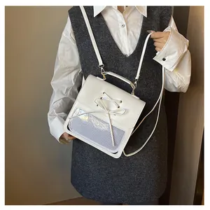 Detailed view of white PU leather backpack with bow tie and mesh window on a model