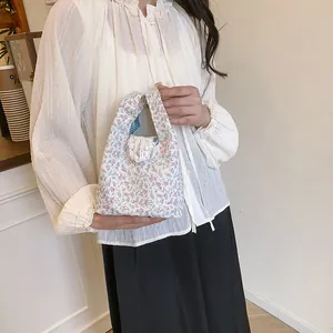 Floral canvas bucket bag with white lace trim and spring flower pattern in soft pastels