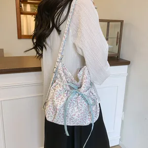Floral bucket shoulder bag with pastel flowers and blue gingham ribbon detail