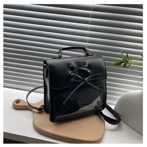 Close-up of black backpack featuring a transparent window and ribbon bow decoration