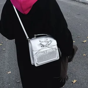 Silver mirror finish backpack with decorative bow and transparent mesh pocket detail