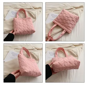 Detail view of pink quilted heart tote bag showing the snap closure and nylon texture