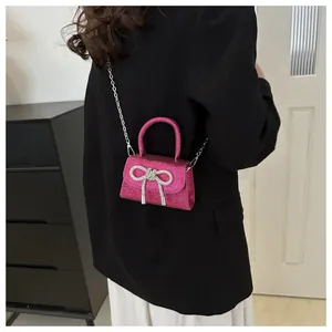 Detailed back view of a mini sequins crossbody bag with a silver bow and chain strap