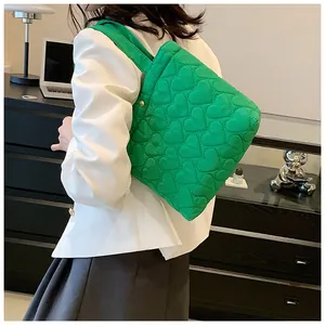 Close-up of bright green quilted heart tote bag showing the soft texture and stitching