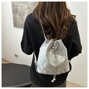 Sac à dos seau argenté avec bandoulière chaîne et détails de perles de serrage