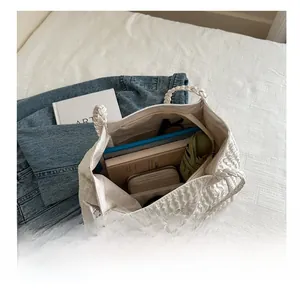 Top view of white pleated tote bag interior showing spacious capacity for tablets and daily items