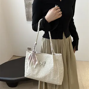 White textured tote bag with silver butterfly and woven handle for stylish women