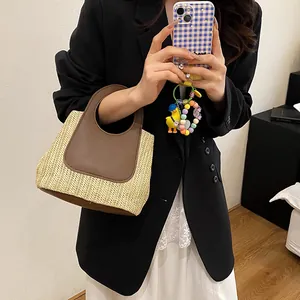 Contrast stitching straw woven tote bag with brown leather handles and spacious interior