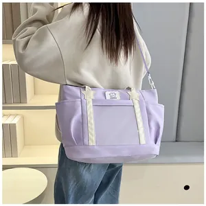 Close-up of light purple nylon tote bag featuring star pendants and side pocket