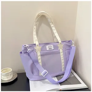 Detail of lavender ita bag with clear window, star charms and adjustable crossbody strap