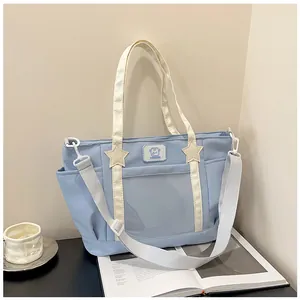 Close-up of a light blue ita bag with a clear PVC window and star stitching details