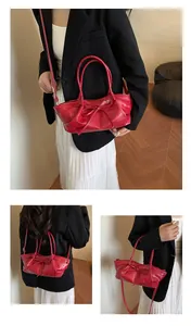 Three-way view of red woven handbag with bow detail and adjustable shoulder strap