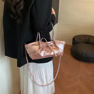 Metallic pink woven handbag for women with bow detail and adjustable shoulder strap