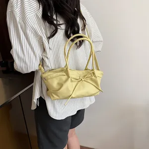 Fashionable woven bucket bag in pale yellow PU leather with delicate bow detail for women