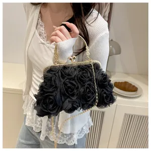 Close-up of 3D black mesh rose floral detail on an elegant evening clutch with gold handle