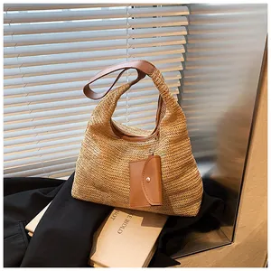 Detailed straw weave pattern on beige shoulder bag with brown leather strap and coin purse