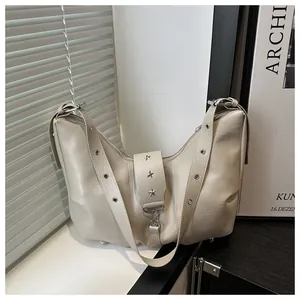 Beigefarbene Schultertasche aus Kunstleder mit Sternnieten und Ösenriemen