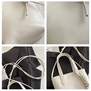 Detailansichten der cremefarbenen Modetasche mit Ledertextur, Knotendetails und Logoprägung