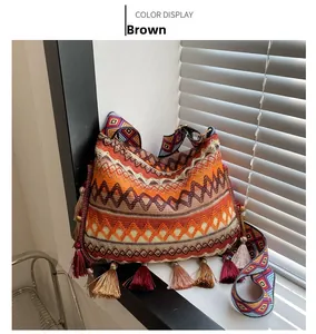 Detail of a brown bohemian woven tote bag featuring geometric patterns and fringe