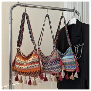 Detailed close-up of bohemian tassel crossbody bags with geometric weave and fringe