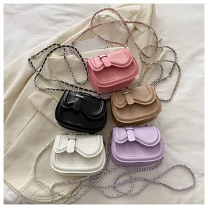 Detail of five stylish mini wave crossbody bags with silver buckles and chain straps