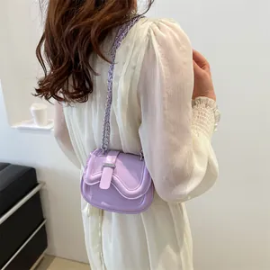 Lavender minimalist saddle bag with wavy edge and silver chain strap on model